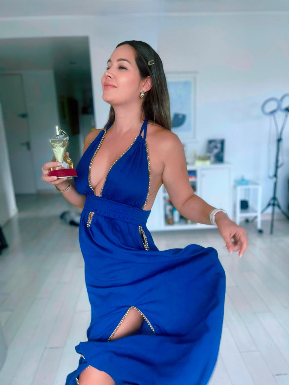 woman wearing long blue rayon maxi dress with golden bead details, sleeveless halter neckline