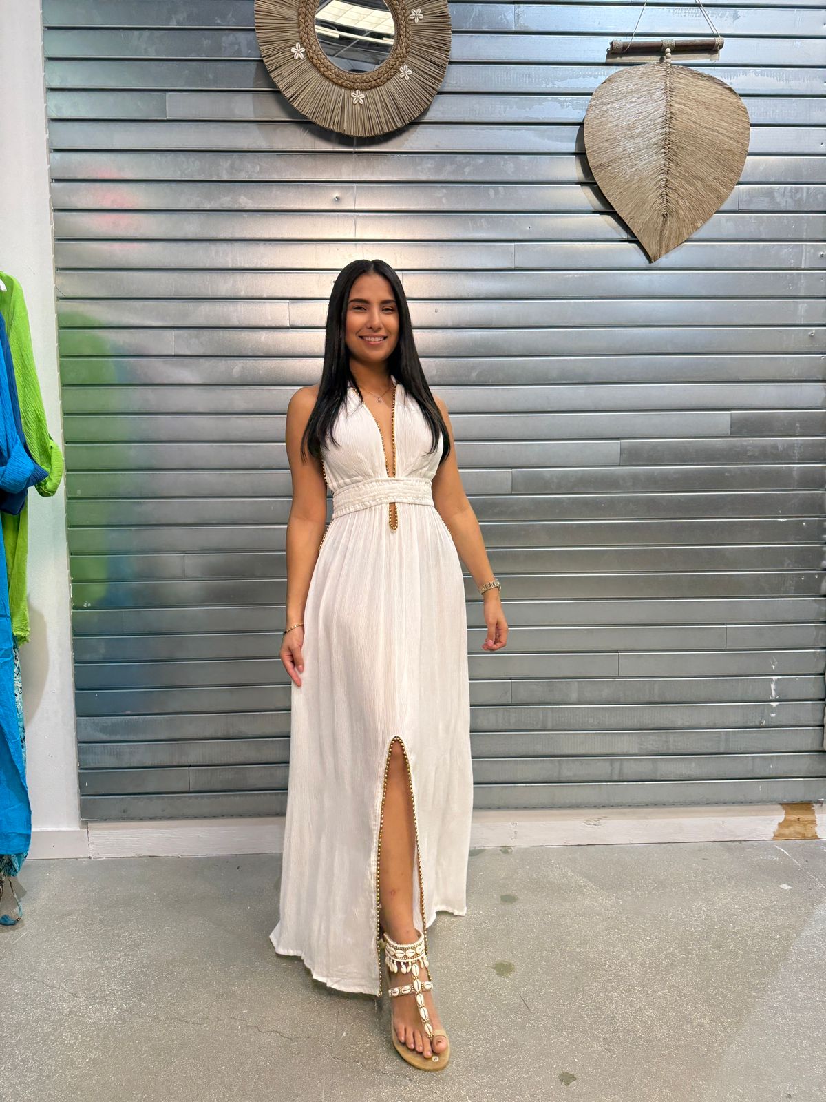women wearing long white rayon dress with deep V-neckline, sleeveless desing, and front slit
