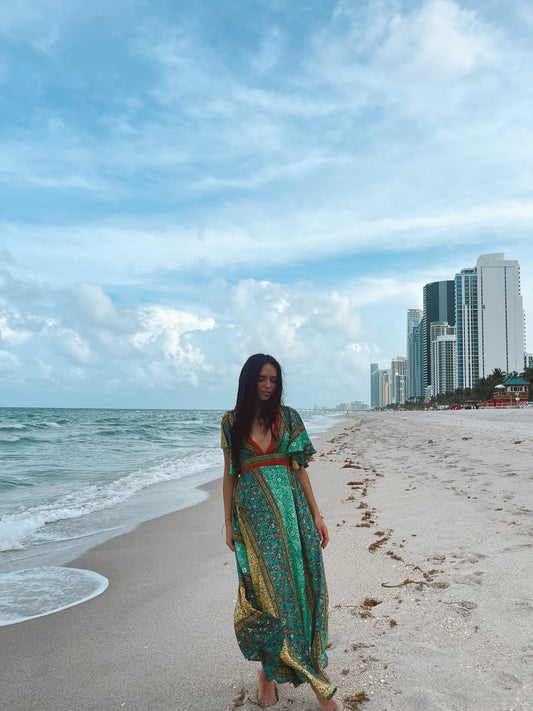 woman wearing long Indian viscose dress with deep V- neckline and tied back, available in various colors