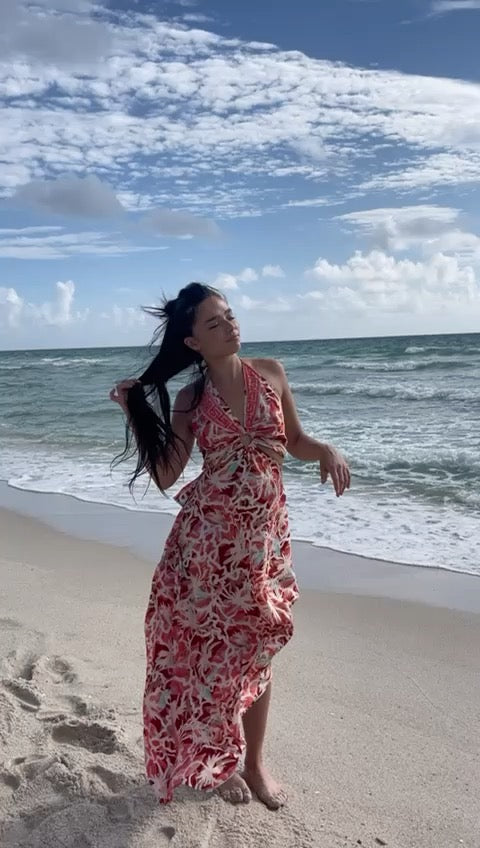 Model at the beach wearing a multicolor silk maxi dress with open back tie