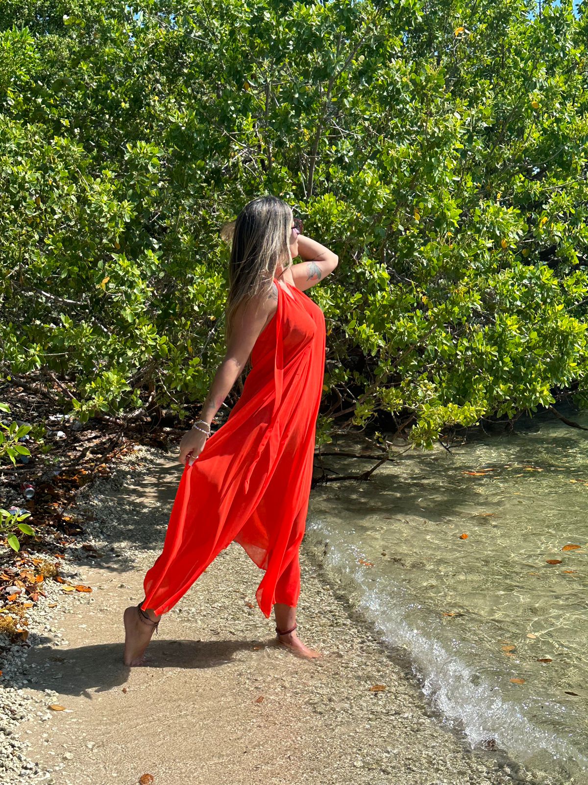 Woman wearing Scarlet Dress, long red maxi dress, summer resort outfit