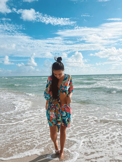 Model on the beach wearing the selena set , a multicolor silk short and crop top, one size