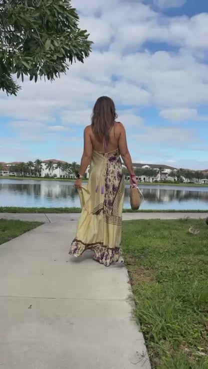 video of woman walking in long brown floral dress with open back, one size, perfect for summer or outdoor events